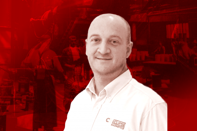 A man in a white shirt against a red background